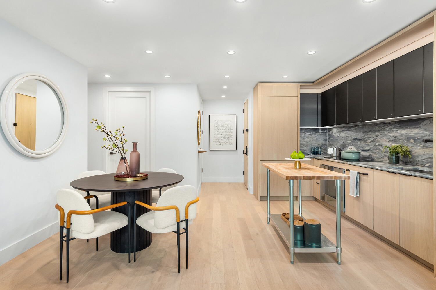499 9th Avenue, Unit 5DN Manhattan, NY 10018 - Photo 6 of 8 a kitchen with stainless steel appliances kitchen island granite countertop a sink and a stove
