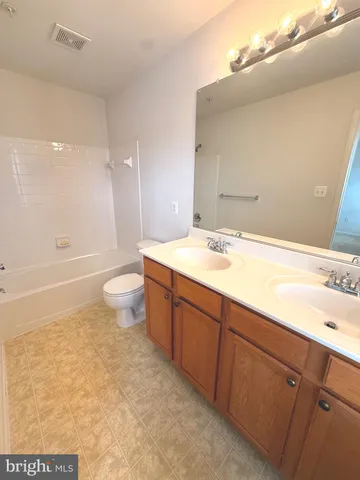 a bathroom with a sink a toilet and bathtub