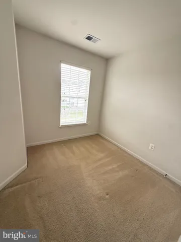 a view of an empty room and a window