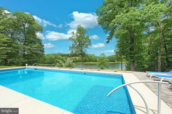 a bathroom with a sink and mirror with toilet