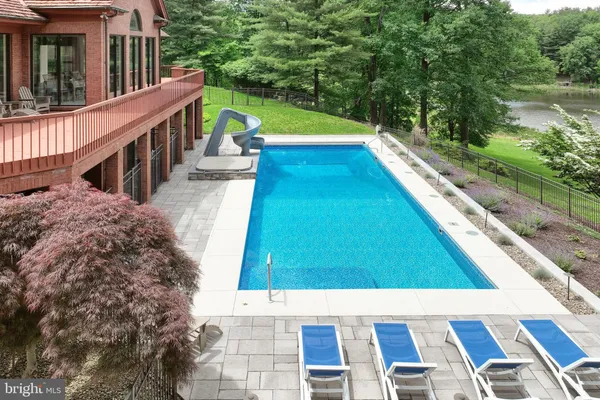 a bedroom with a bed and large windows