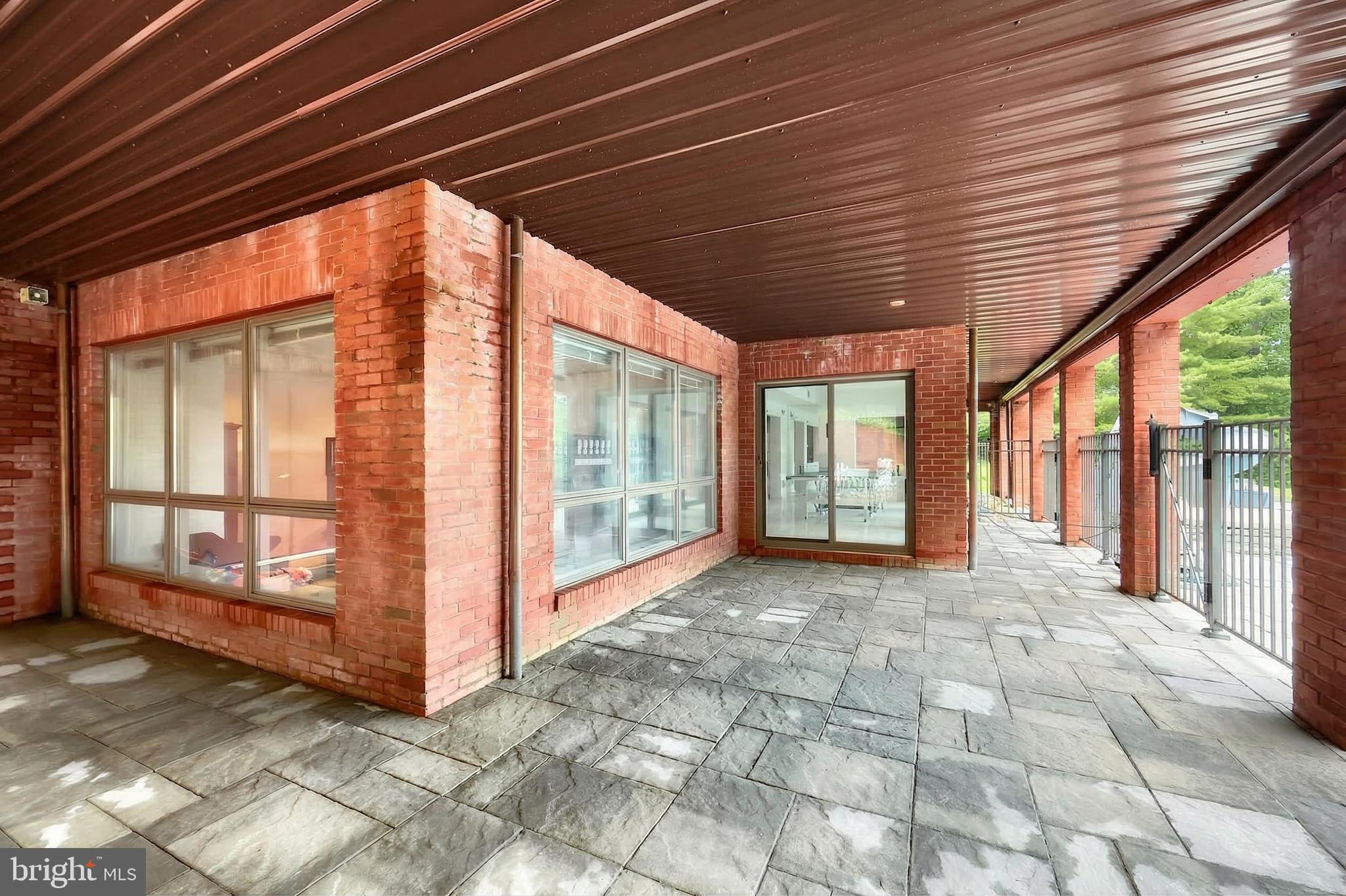 174 Springhouse Lane Spring Grove, PA 17362 - Photo 25 of 95 a view of a porch with furniture and floor to ceiling window