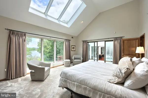 a bedroom with two beds and large window