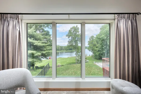 a bedroom with two beds and painting on the wall