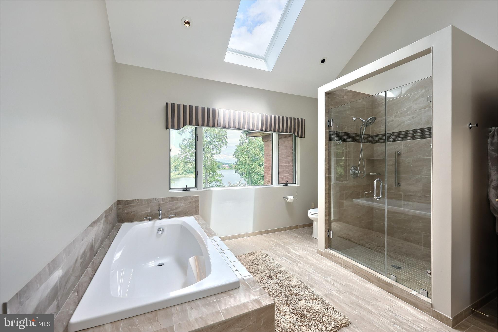 174 Springhouse Lane Spring Grove, PA 17362 - Photo 39 of 95 a bathroom with a tub a window and a shower