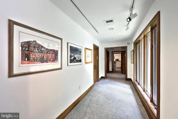 a living room with furniture a mirror and a flat screen tv