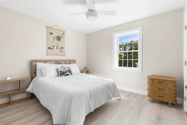 a bedroom with a bed and a window