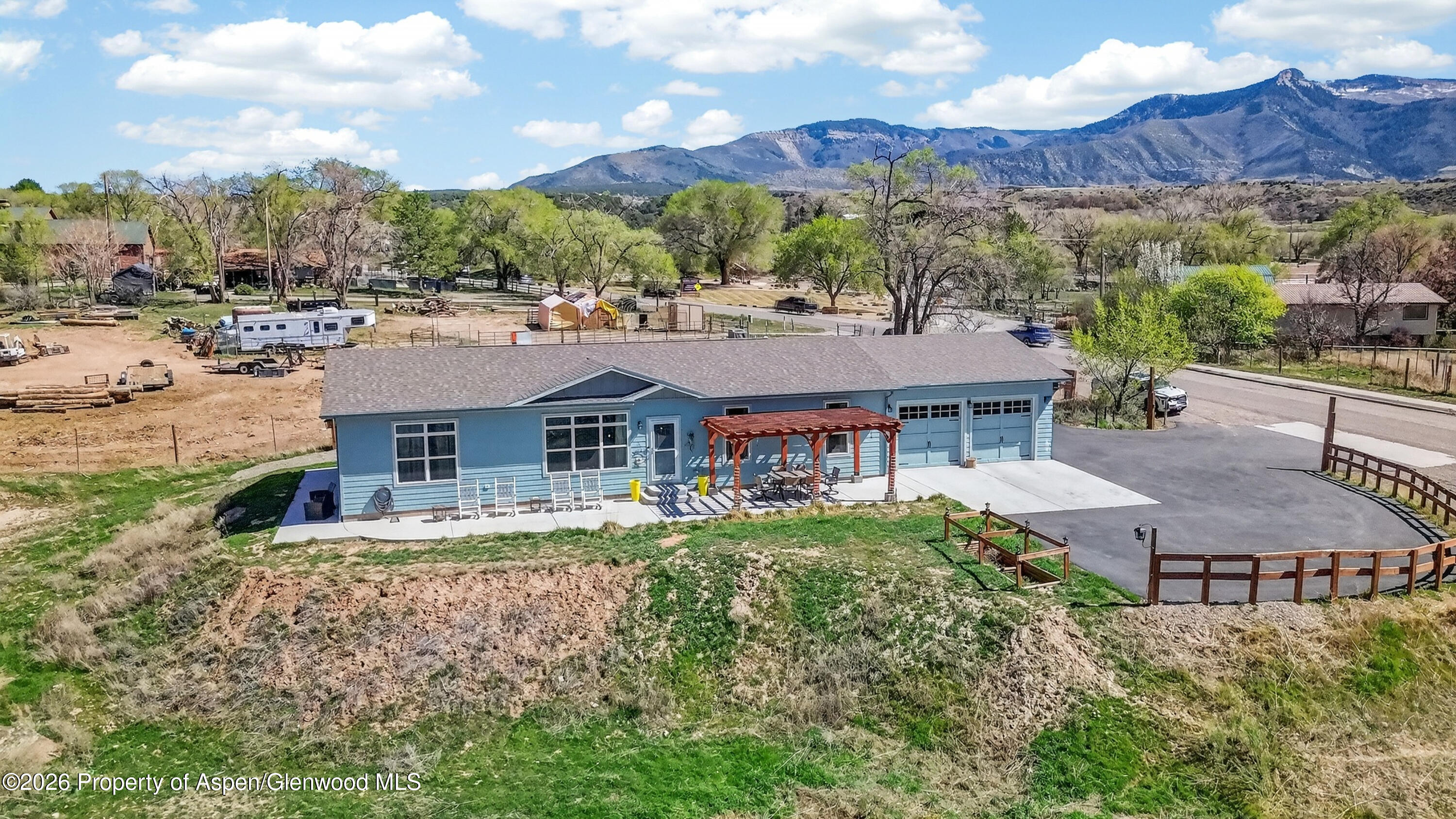 19 County Road 301 Parachute, CO 81635 - Photo 1 of 35 a view of a big house with a big yard and large tree
