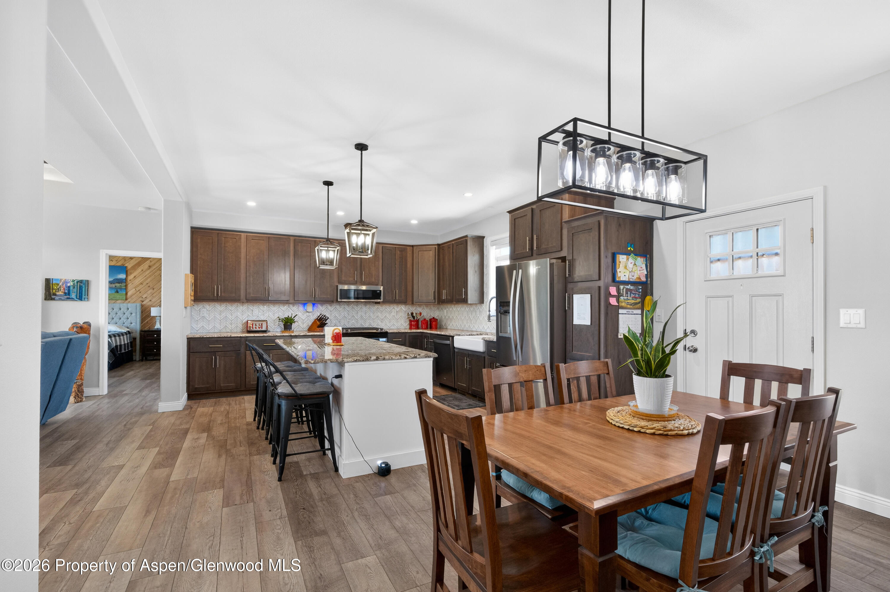 19 County Road 301 Parachute, CO 81635 - Photo 16 of 35 a view of a dining room and livingroom with furniture wooden floor a chandelier