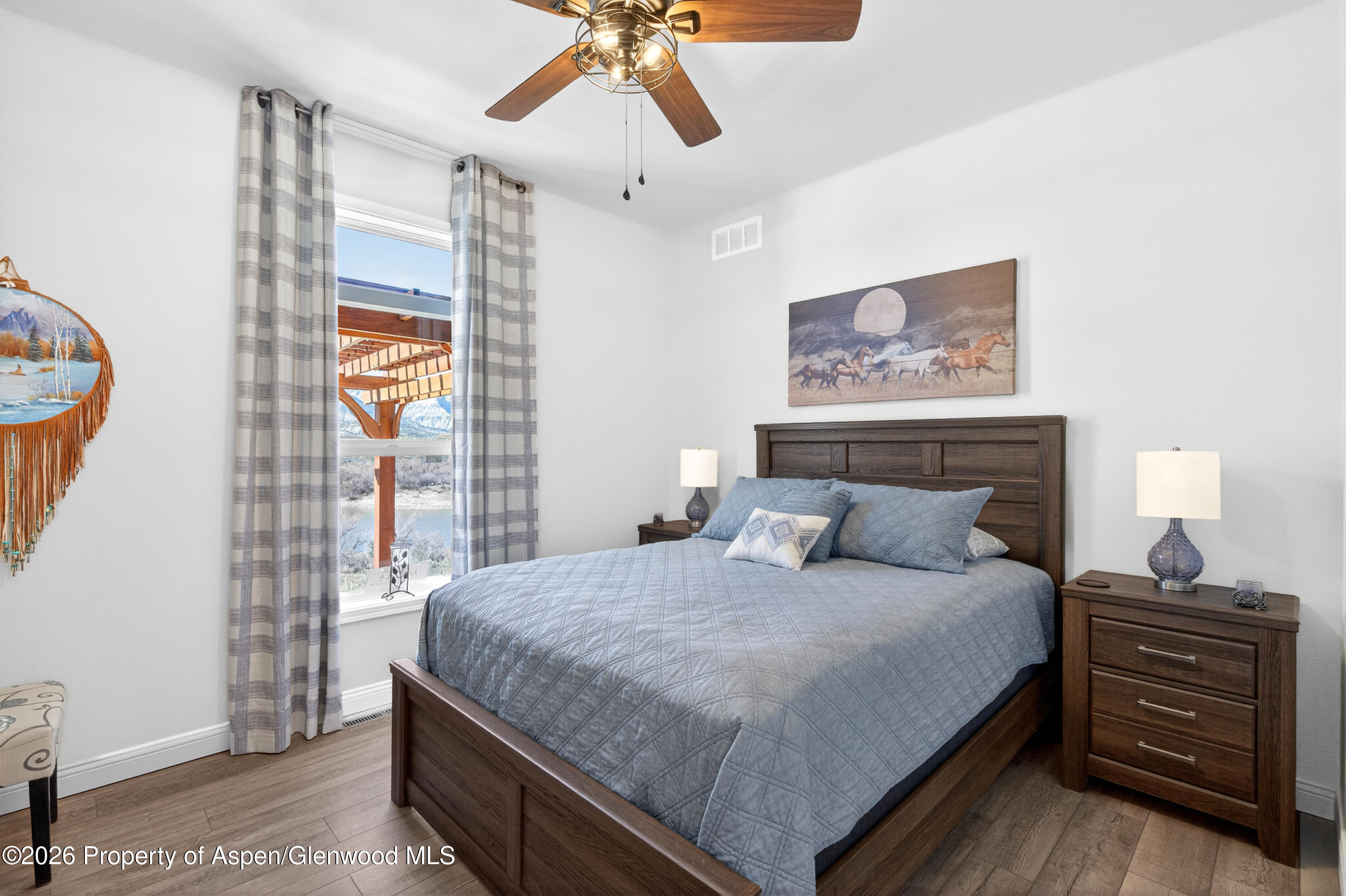 19 County Road 301 Parachute, CO 81635 - Photo 28 of 35 a bedroom with a bed and wooden floor