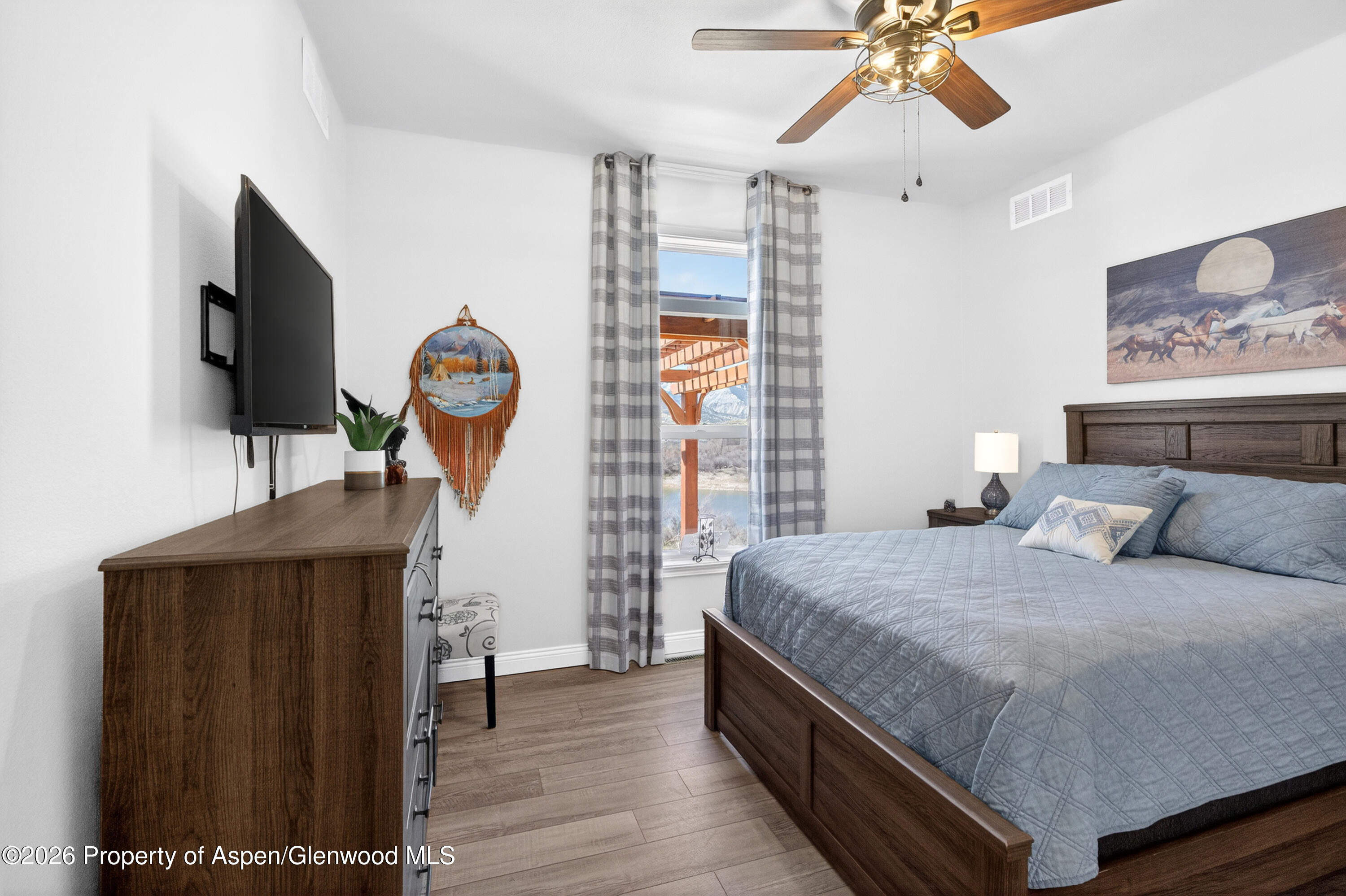 19 County Road 301 Parachute, CO 81635 - Photo 29 of 35 a bedroom with a bed and a chandelier