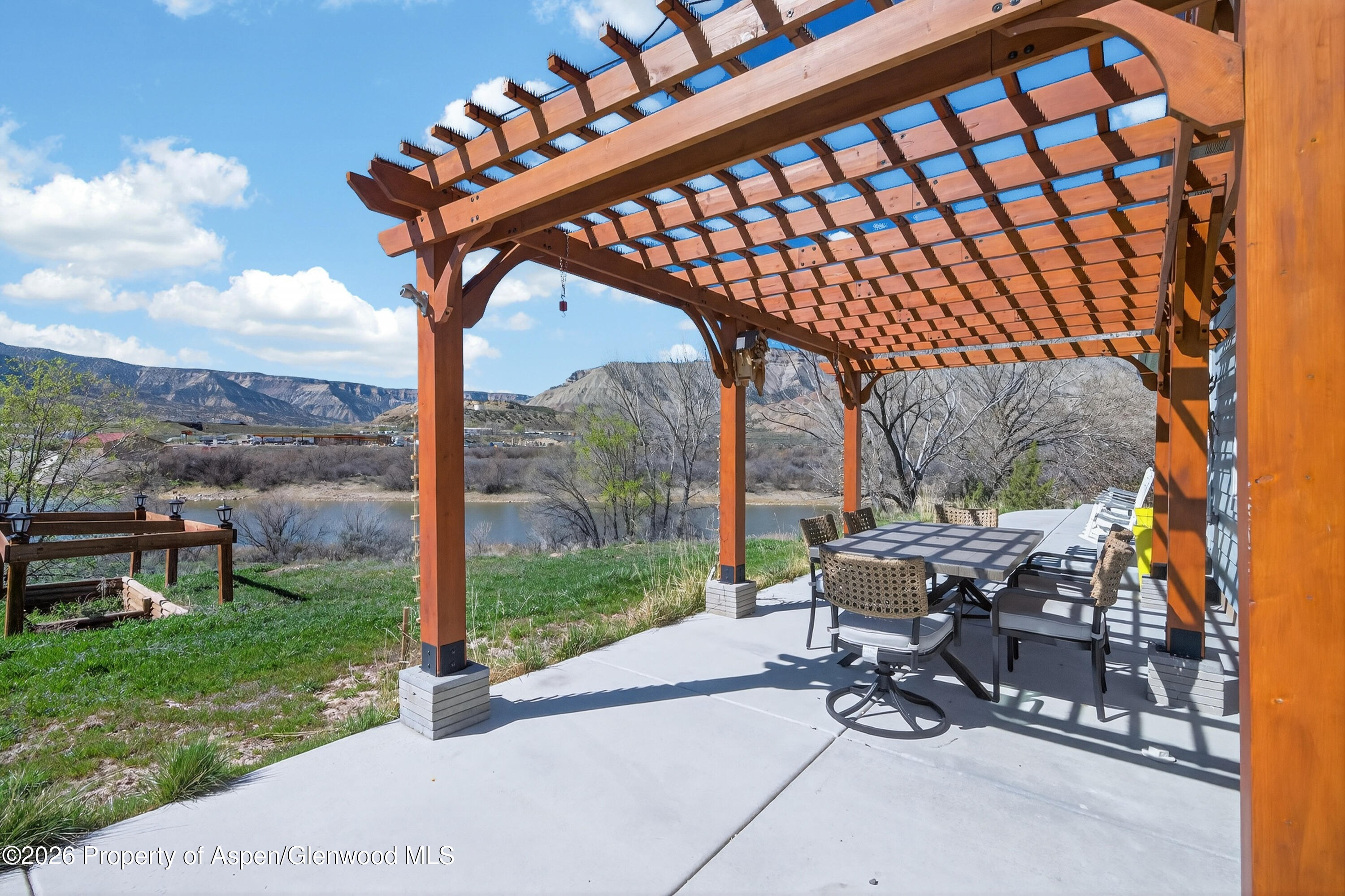 19 County Road 301 Parachute, CO 81635 - Photo 3 of 35 a view of a patio with a table chairs and a backyard