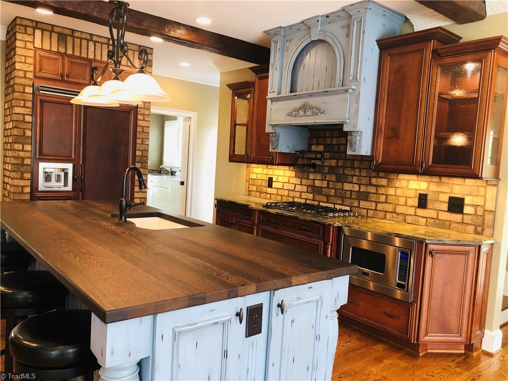 150 Jd Essick Road Lexington, NC 27295 - Photo 13 of 49 Cook's dream kitchen with built-in refrigerator and stainless Viking appliances.