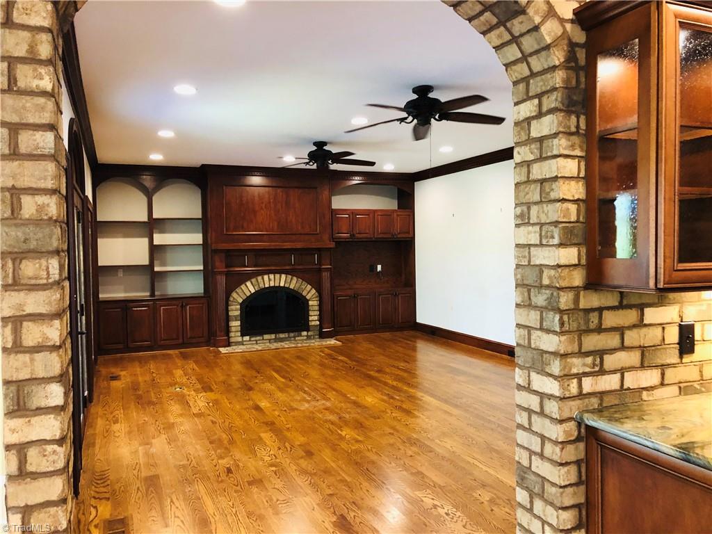 150 Jd Essick Road Lexington, NC 27295 - Photo 19 of 49 Lovely, symmetrical arched details displayed through kitchen entryway leading to family room, built-ins and fireplace