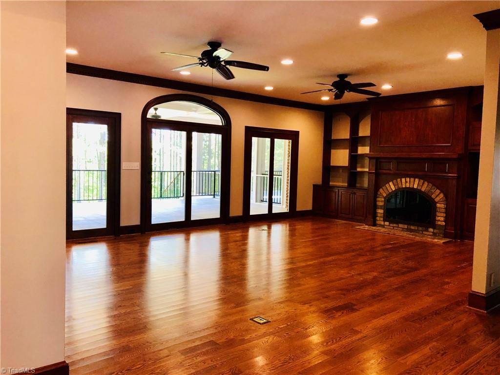 150 Jd Essick Road Lexington, NC 27295 - Photo 20 of 49 Sophisticated and spacious family room, situated on the rear of the home opens to a lovely covered porch overlooking backyard with lake view.
