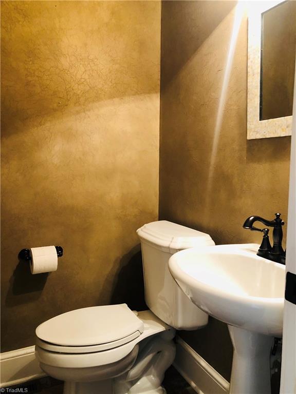 150 Jd Essick Road Lexington, NC 27295 - Photo 22 of 49 One of two half baths. Pictured is the one in kitchen area, immediately inside exterior door leading to triple carport. The second half bath is located in the center of the main level, ideal for guest use