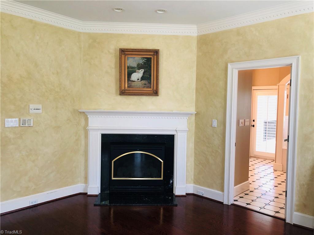 150 Jd Essick Road Lexington, NC 27295 - Photo 26 of 49 Primary bedroom with fireplace on main level opens to bathroom suite leading to peaceful and serene screened porch...Perfect for relaxing with privacy.