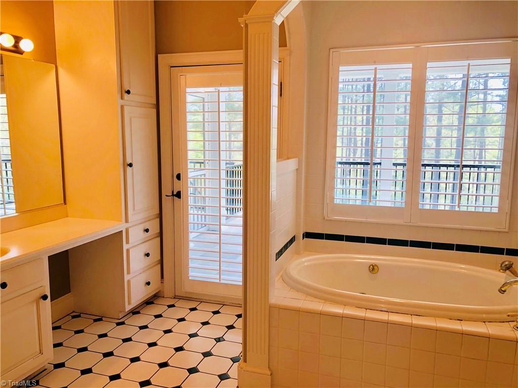 150 Jd Essick Road Lexington, NC 27295 - Photo 27 of 49 Primary bathroom houses separate soaker tub and walk-in shower. Dual walk-in his/hers closets. Bathroom opens to it's very own private screened porch.