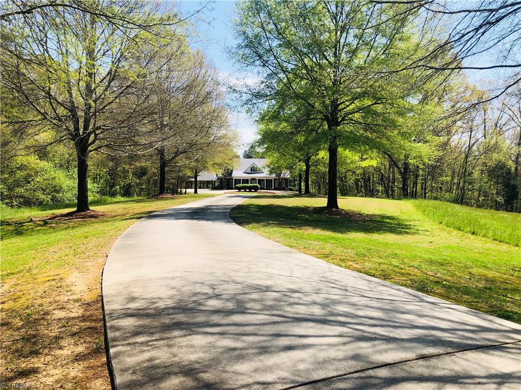 150 Jd Essick Road Lexington, NC 27295 - Photo 4 of 49 Tree lined, paved driveway leads to this lovely custom built home tucked away on private waterfront lot