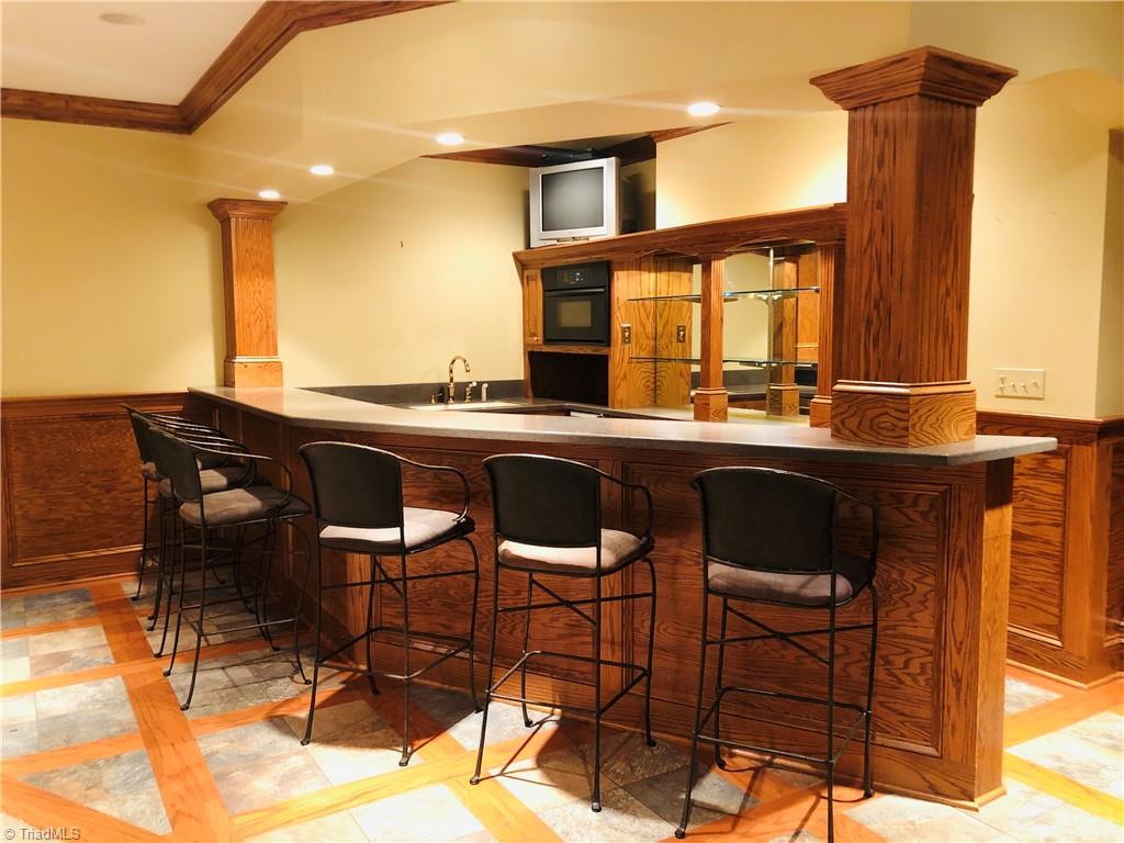 150 Jd Essick Road Lexington, NC 27295 - Photo 31 of 49 Bar in basement sets the stage for the perfect gathering or inlaw/guest/teen suite. The bar is located within the game/family room and close to the home theater and library.