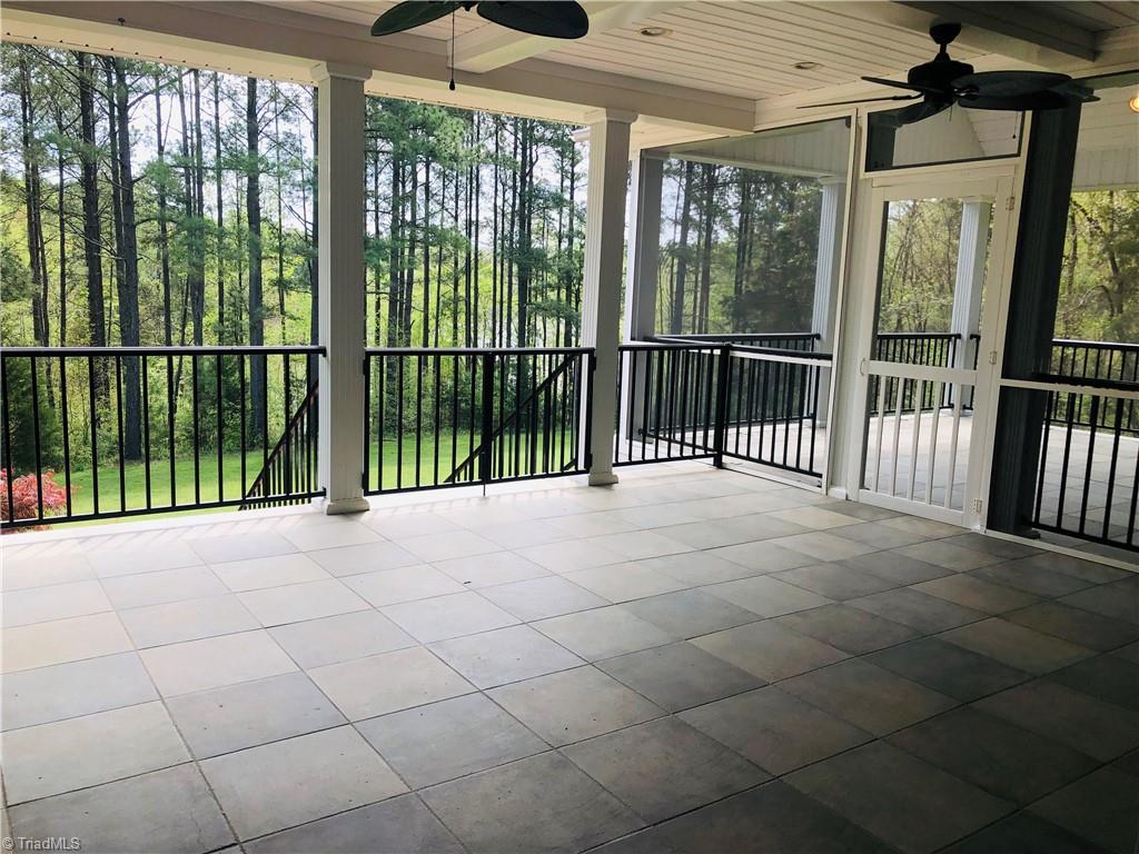 150 Jd Essick Road Lexington, NC 27295 - Photo 40 of 49 Peaceful covered porch off of family room and kitchen adjoins primary bedroom screened porch.
