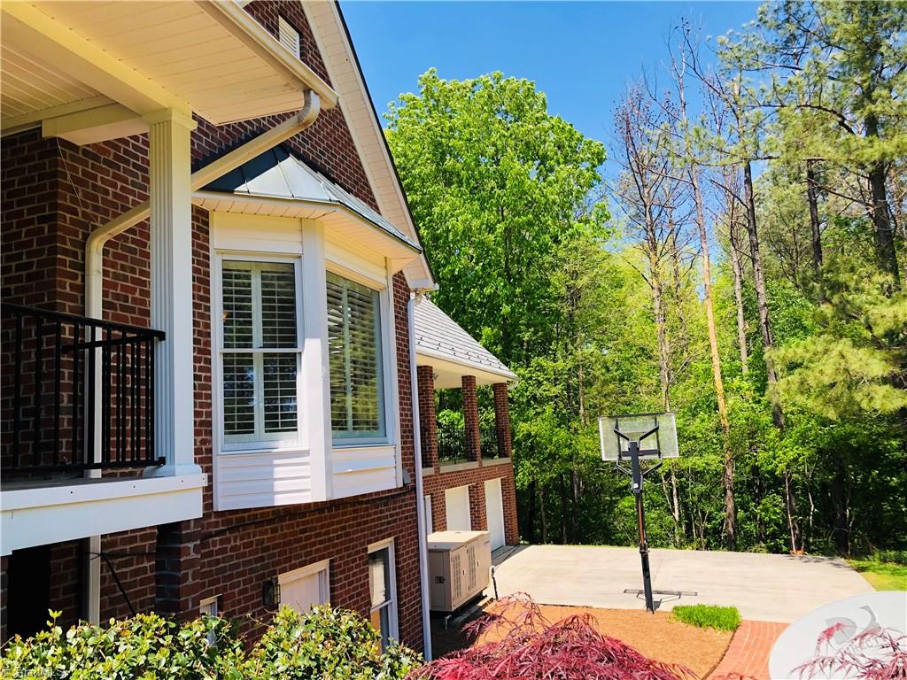 150 Jd Essick Road Lexington, NC 27295 - Photo 43 of 49 Basketball court in rear near exterior basement/workout room entrance. This is a perfect home for all ages to spread out. It also lends itself to living on the main level only with extra space for family visits, holidays, guests.