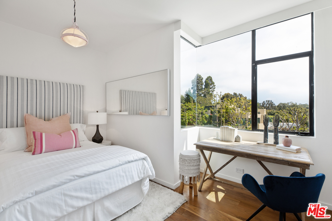 640 East Channel Road Santa Monica, CA 90402 - Photo 19 of 45 a bedroom with a bed and a large window