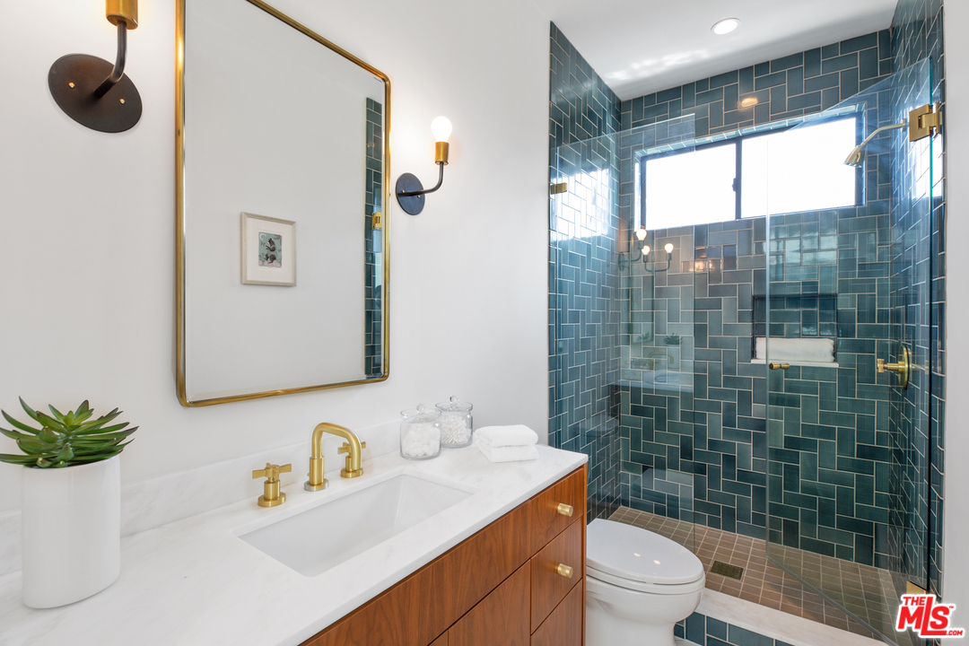 640 East Channel Road Santa Monica, CA 90402 - Photo 22 of 45 a bathroom with a sink a toilet a mirror and shower
