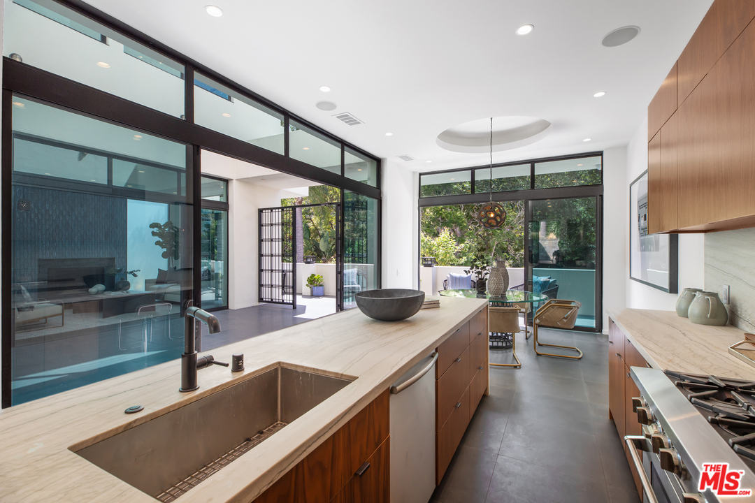 640 East Channel Road Santa Monica, CA 90402 - Photo 9 of 45 a kitchen with stainless steel appliances kitchen island sink stove and cabinets