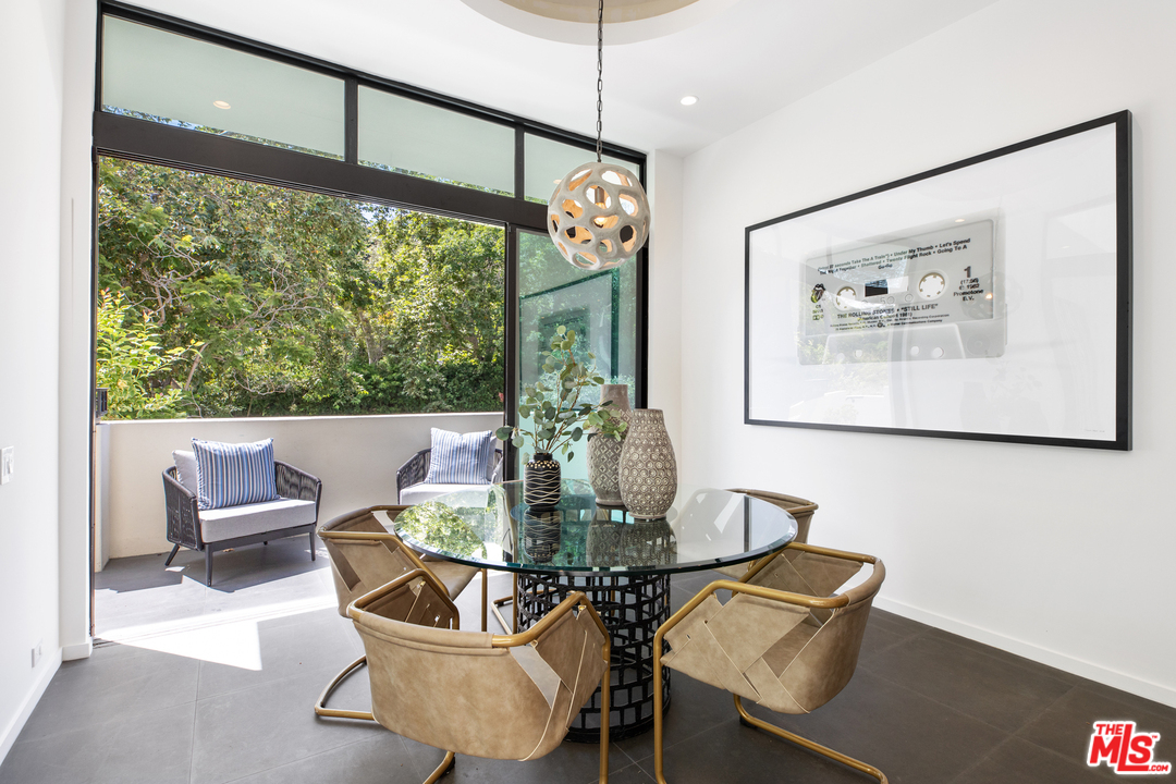 640 East Channel Road Santa Monica, CA 90402 - Photo 10 of 45 a view of a dining room with furniture a chandelier and wooden floor