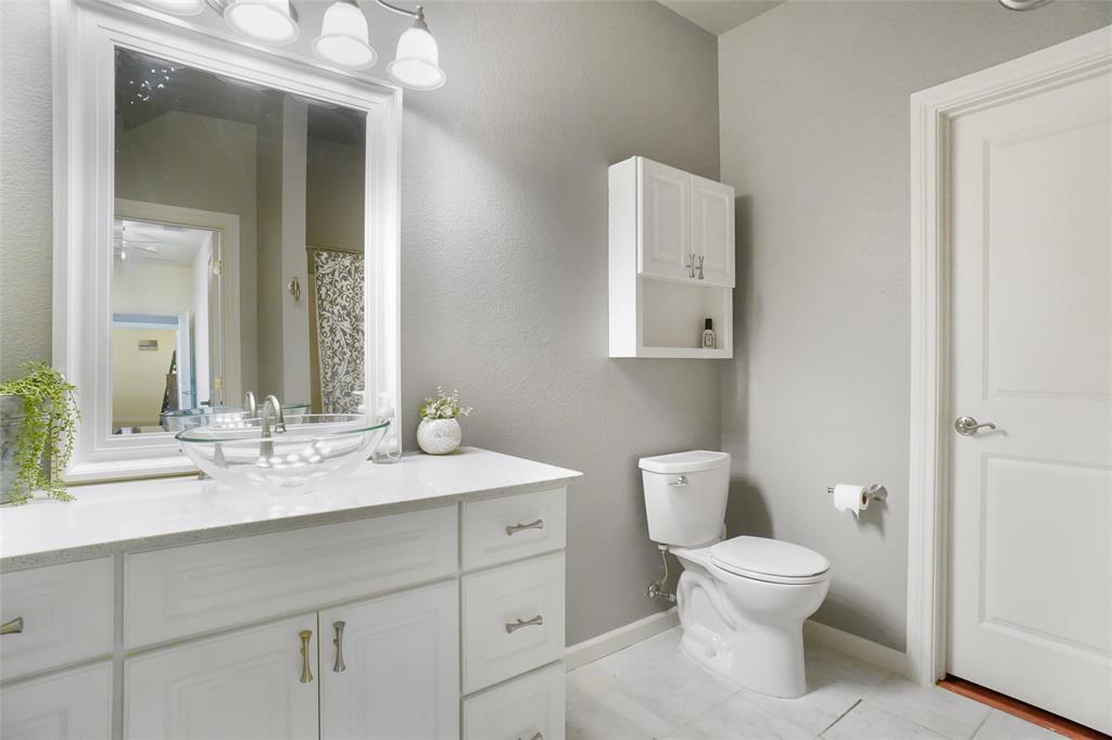 13340 John Day Road Haslet, TX 76052 - Photo 23 of 30 a spacious bathroom with a toilet sink and mirror