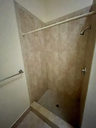 a bathroom with a granite countertop sink a toilet a mirror and bathtub