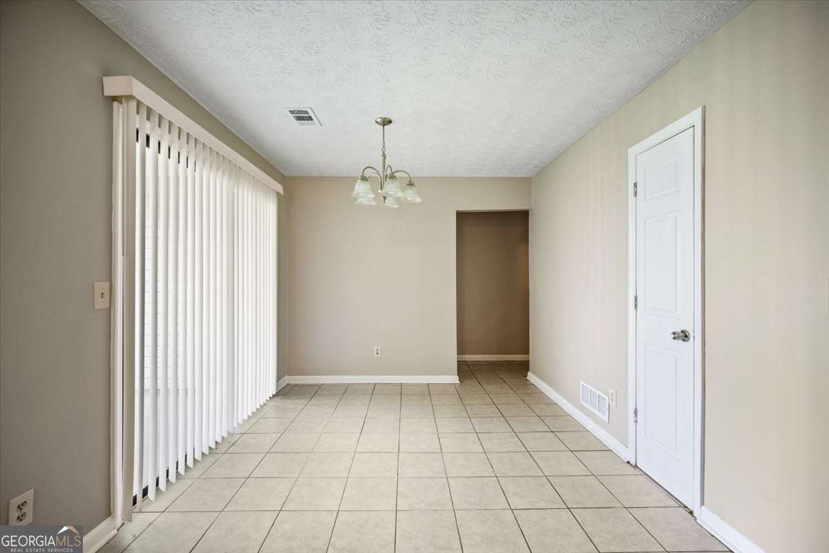 5426 Martins Crossing Road Stone Mountain, GA 30088 - Photo 13 of 26 a view of an empty room with window