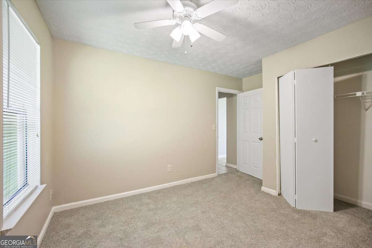 5426 Martins Crossing Road Stone Mountain, GA 30088 - Photo 17 of 26 a view of an empty room with a window