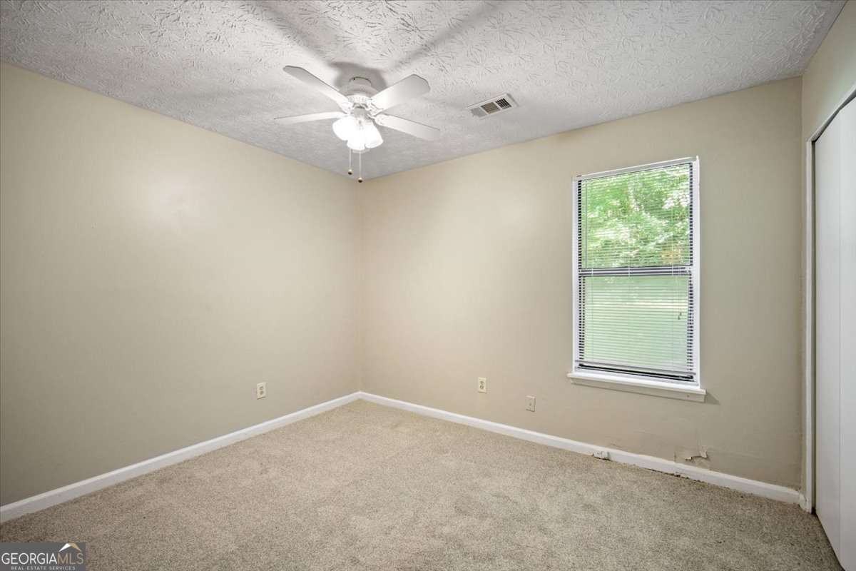 5426 Martins Crossing Road Stone Mountain, GA 30088 - Photo 18 of 26 an empty room with a window