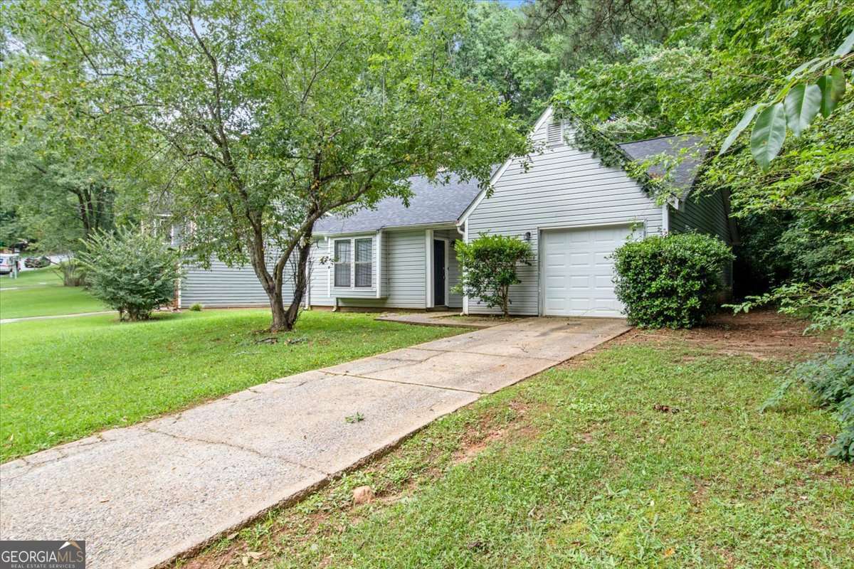 5426 Martins Crossing Road Stone Mountain, GA 30088 - Photo 2 of 26 a front view of a house with a yard