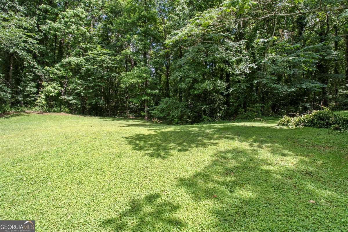 5426 Martins Crossing Road Stone Mountain, GA 30088 - Photo 23 of 26 a view of outdoor space with deck and yard