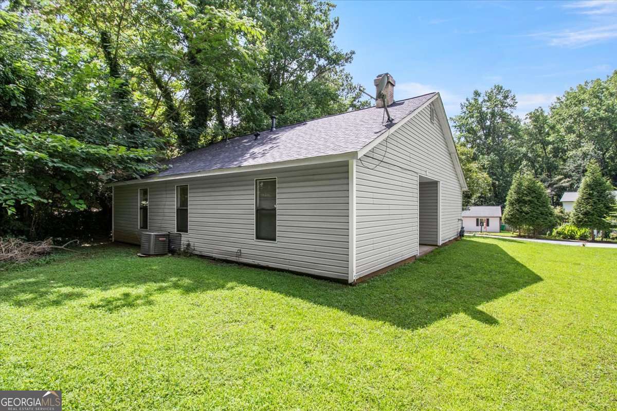 5426 Martins Crossing Road Stone Mountain, GA 30088 - Photo 25 of 26 a view of a house with a yard