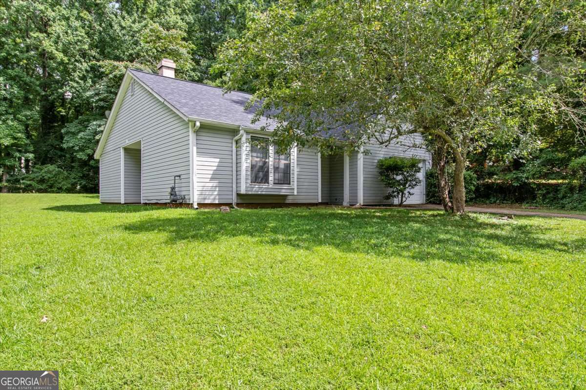 5426 Martins Crossing Road Stone Mountain, GA 30088 - Photo 3 of 26 a front view of house with yard and green space