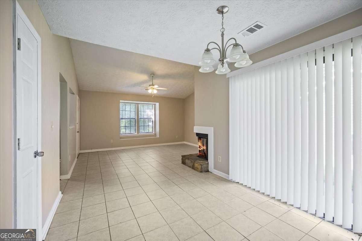 5426 Martins Crossing Road Stone Mountain, GA 30088 - Photo 9 of 26 a view of an empty room with a window