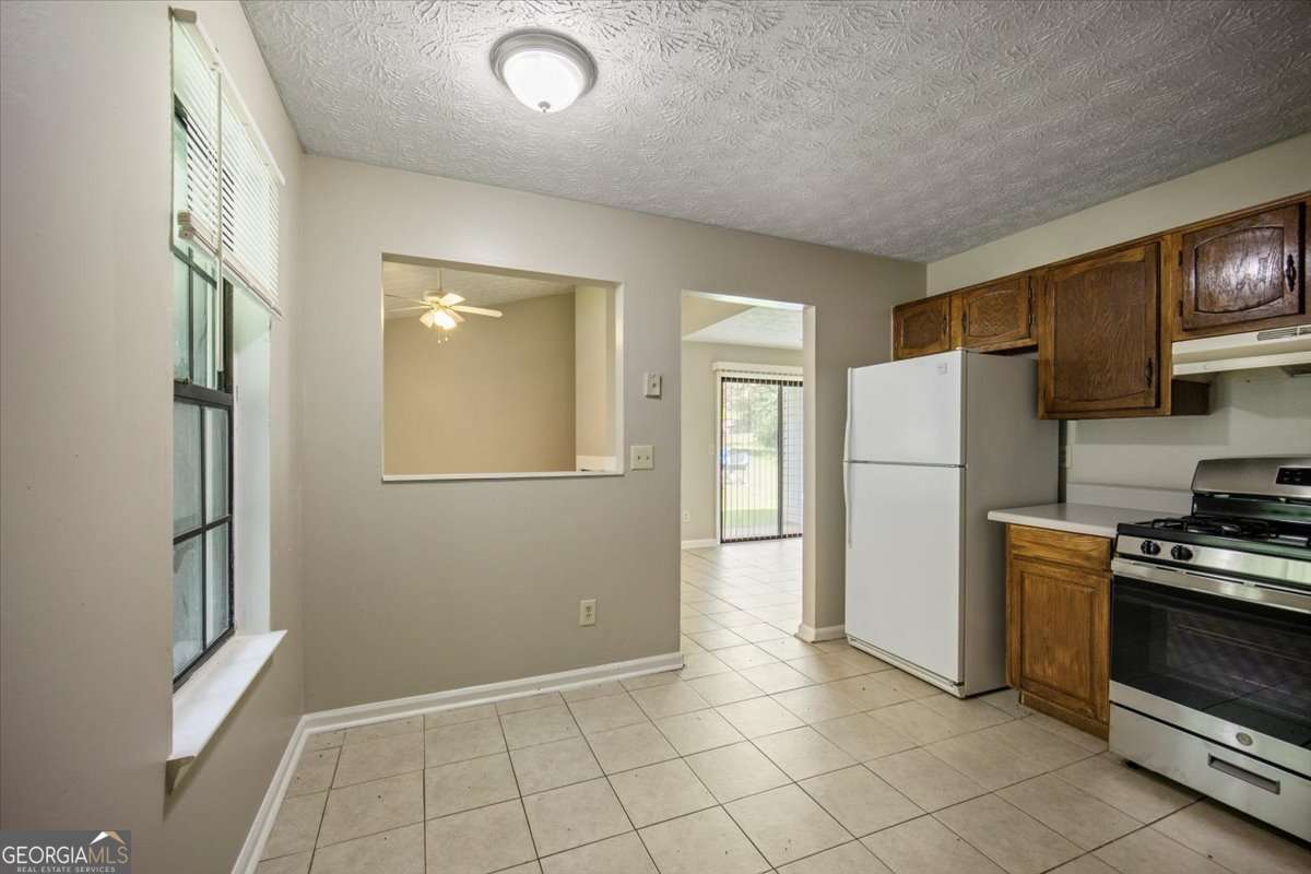 5426 Martins Crossing Road Stone Mountain, GA 30088 - Photo 10 of 26 a view of a kitchen with refrigerator and microwave