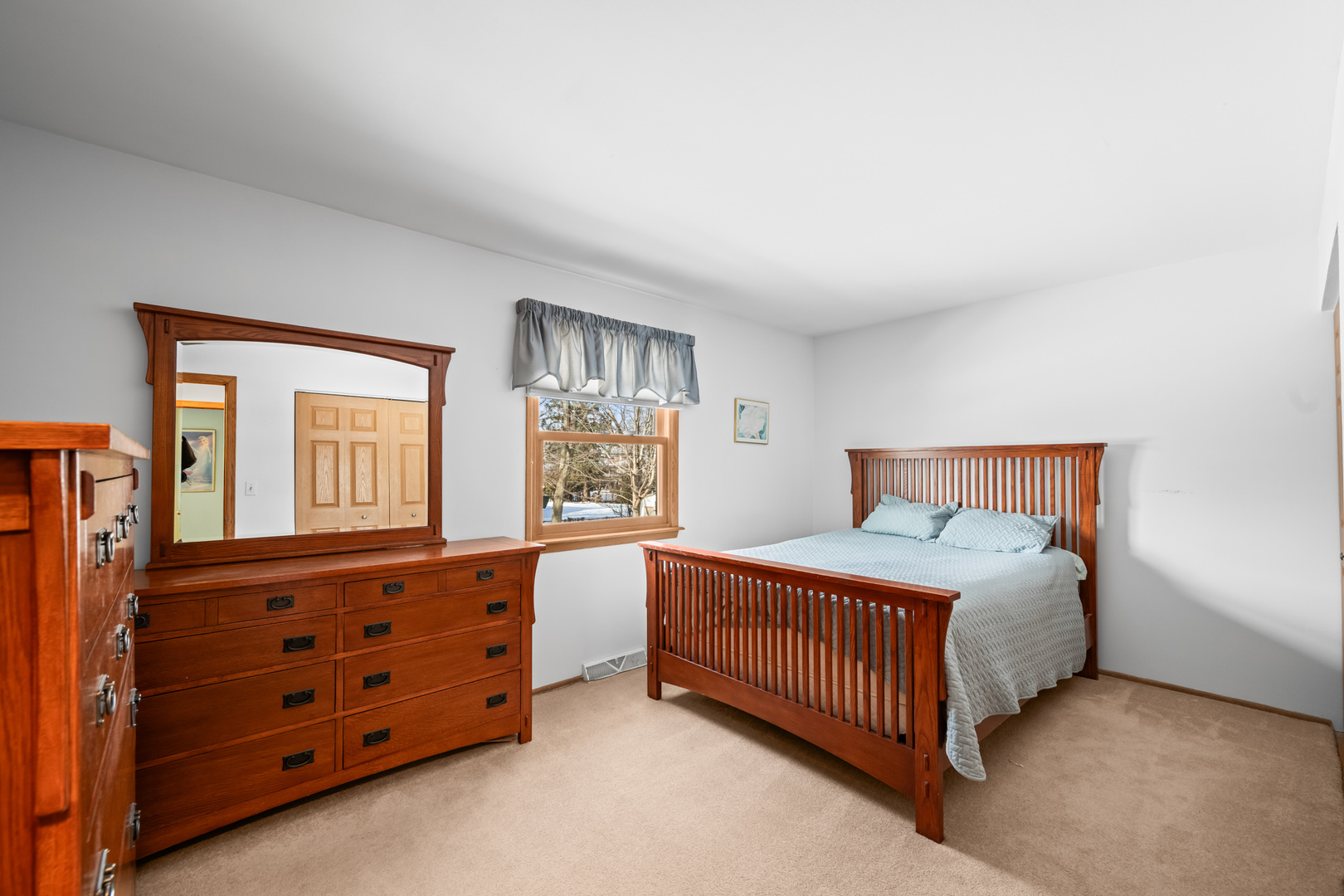 496 Raupp Boulevard Buffalo Grove, IL 60089 - Photo 7 of 19 a bedroom with a bed and a dresser
