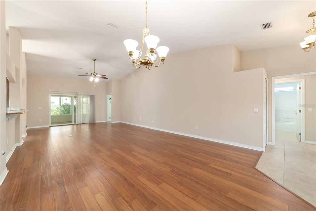 16369 Southwest 14th Avenue Road Ocala, FL 34473 - Photo 11 of 49 a view of an empty room with wooden floor and a window