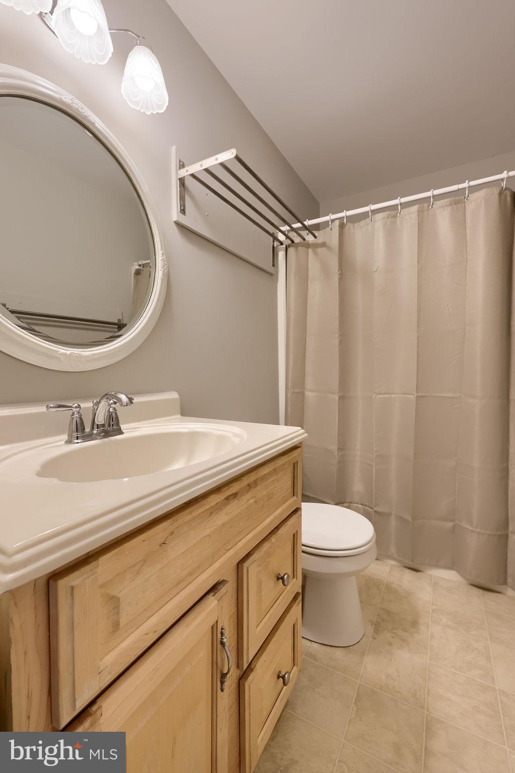 421 Longmeadow Road Lancaster, PA 17601 - Photo 28 of 44 a bathroom with a granite countertop sink toilet and a mirror
