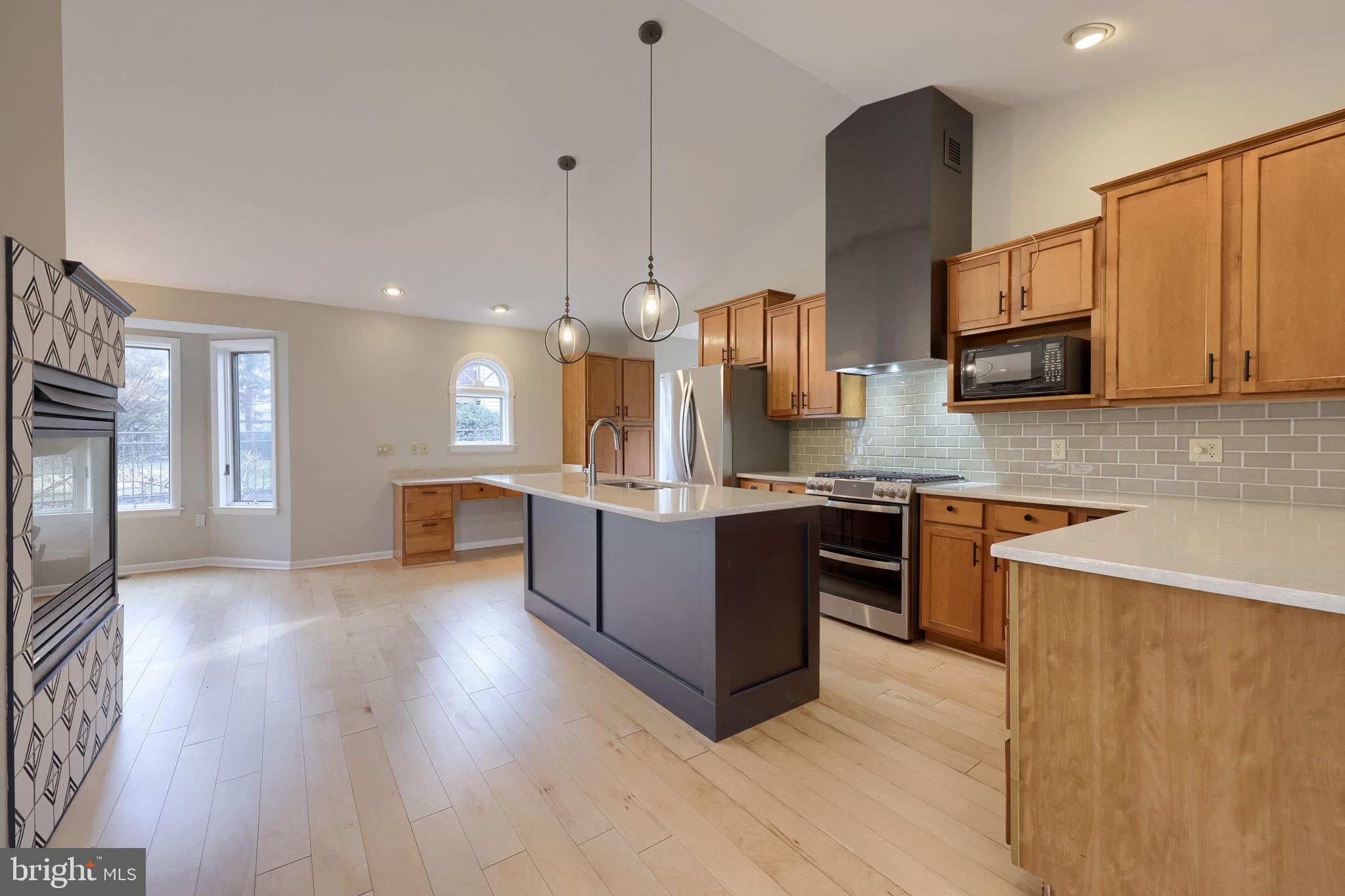 421 Longmeadow Road Lancaster, PA 17601 - Photo 5 of 44 a kitchen with stainless steel appliances kitchen island granite countertop a stove a sink a refrigerator and a wooden cabinets
