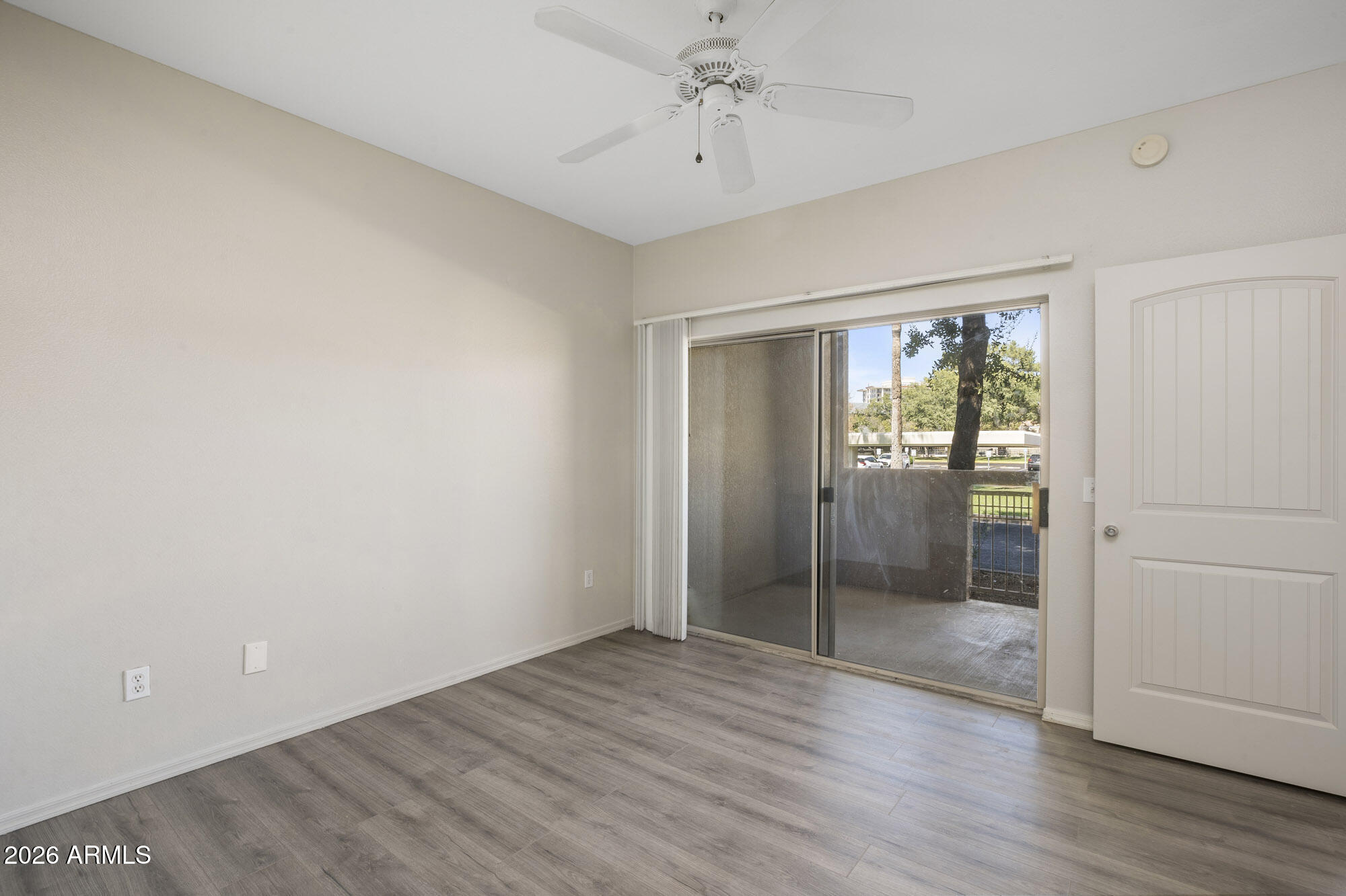 4644 North 22nd Street, Unit 1017 Phoenix, AZ 85016 - Photo 5 of 17 wooden floor in an empty room with a window