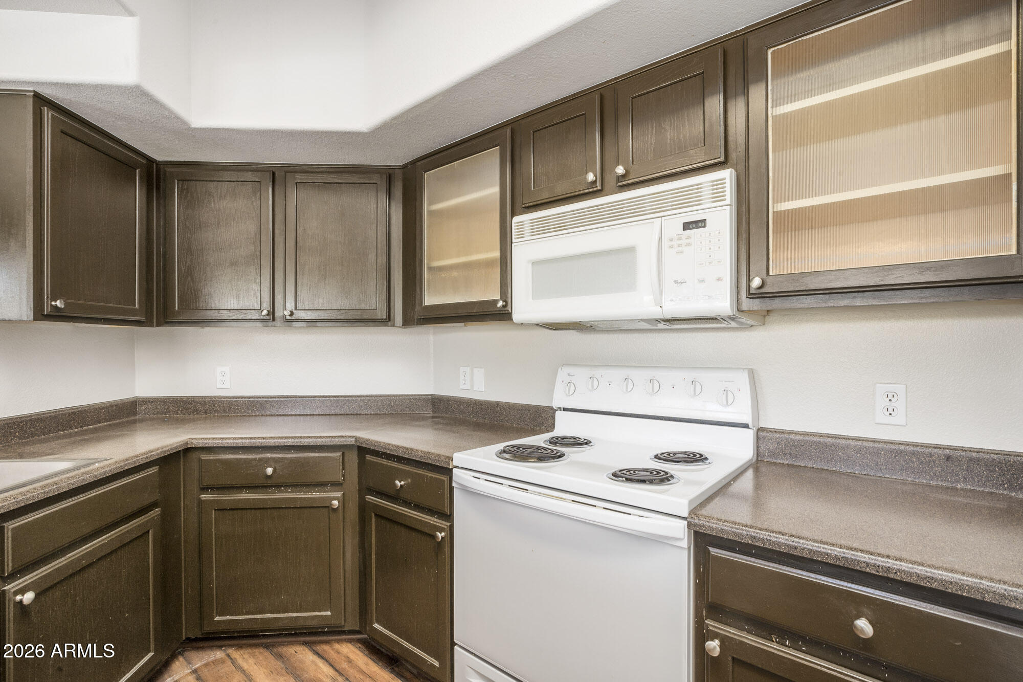 4644 North 22nd Street, Unit 1017 Phoenix, AZ 85016 - Photo 7 of 17 a kitchen with a cabinets and a stove top oven