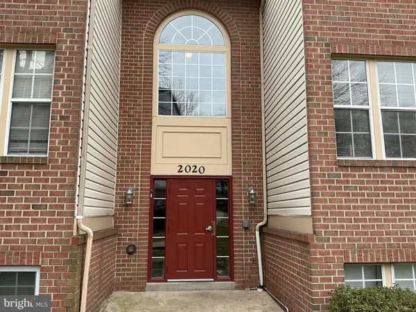 a view of a brick house with large windows