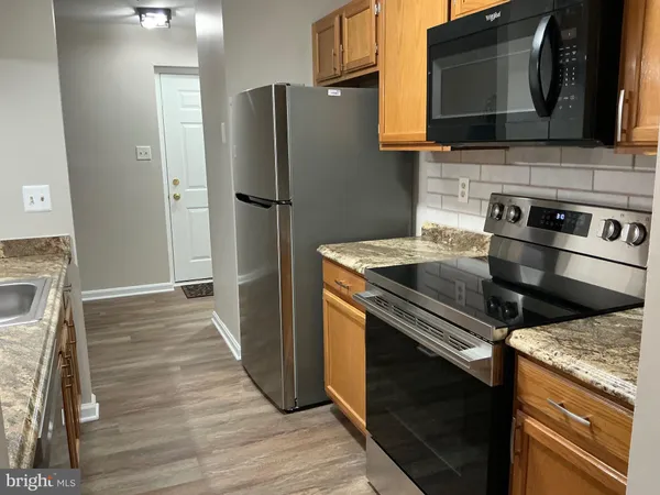 a kitchen with a stove microwave and refrigerator