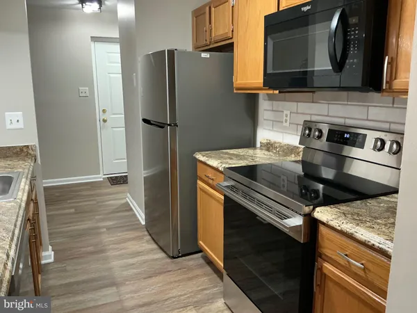 a kitchen with stainless steel appliances a refrigerator stove and microwave